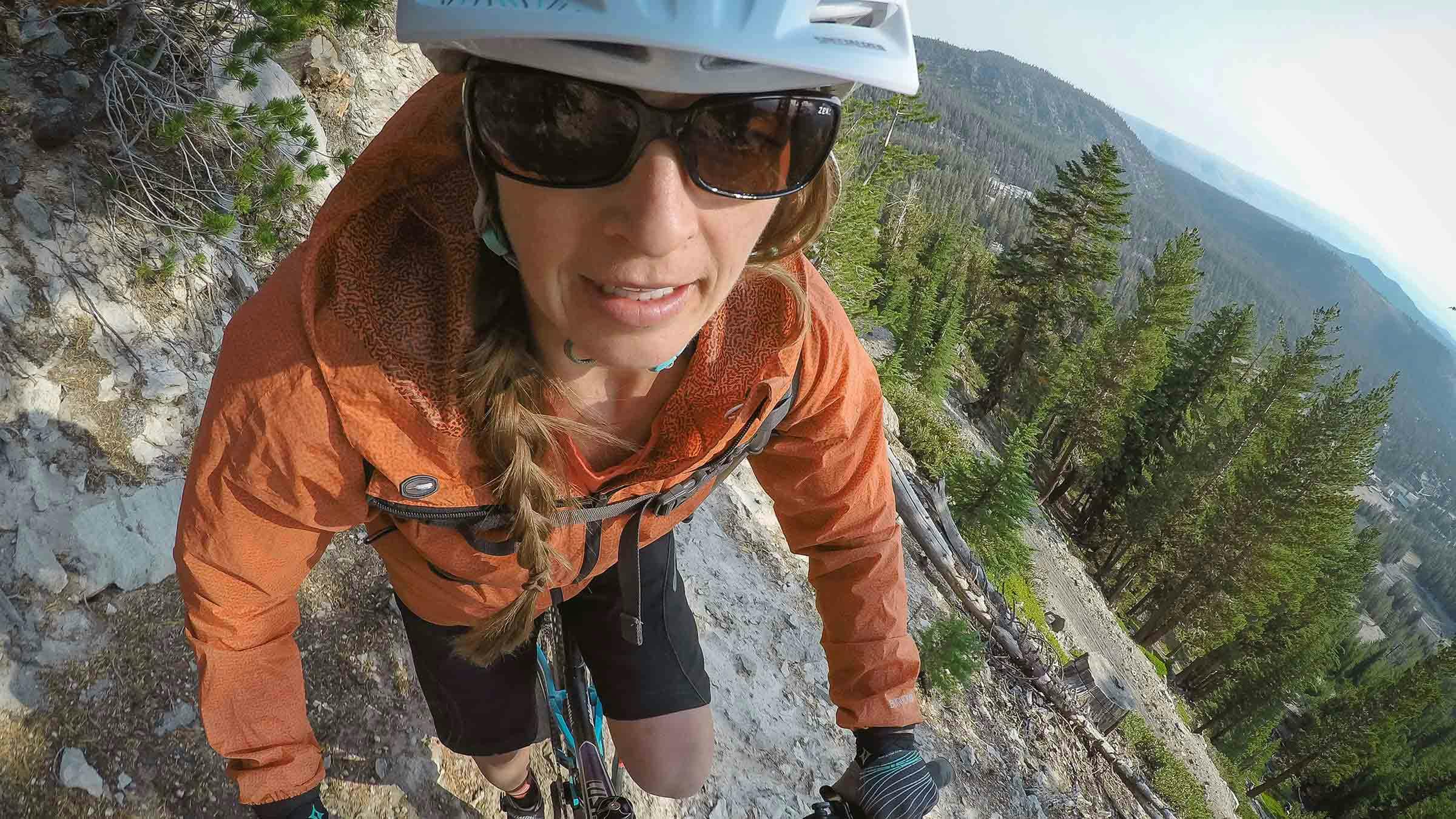 Woman mountain biking using a GoPro camera in the Mammoth Bike Park.