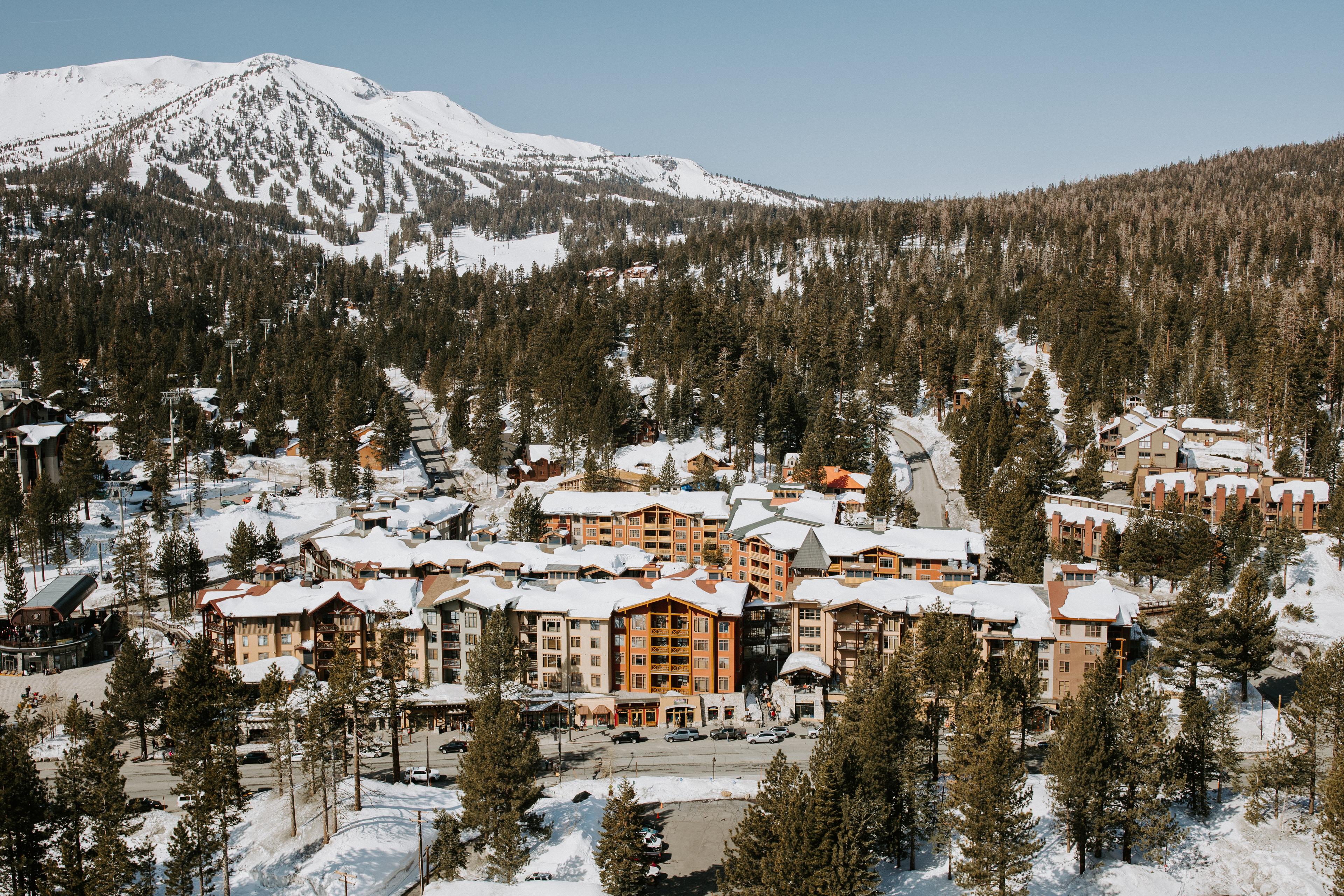 Aerial image of The Village at Mammoth with Mammoth Mountain in the background.