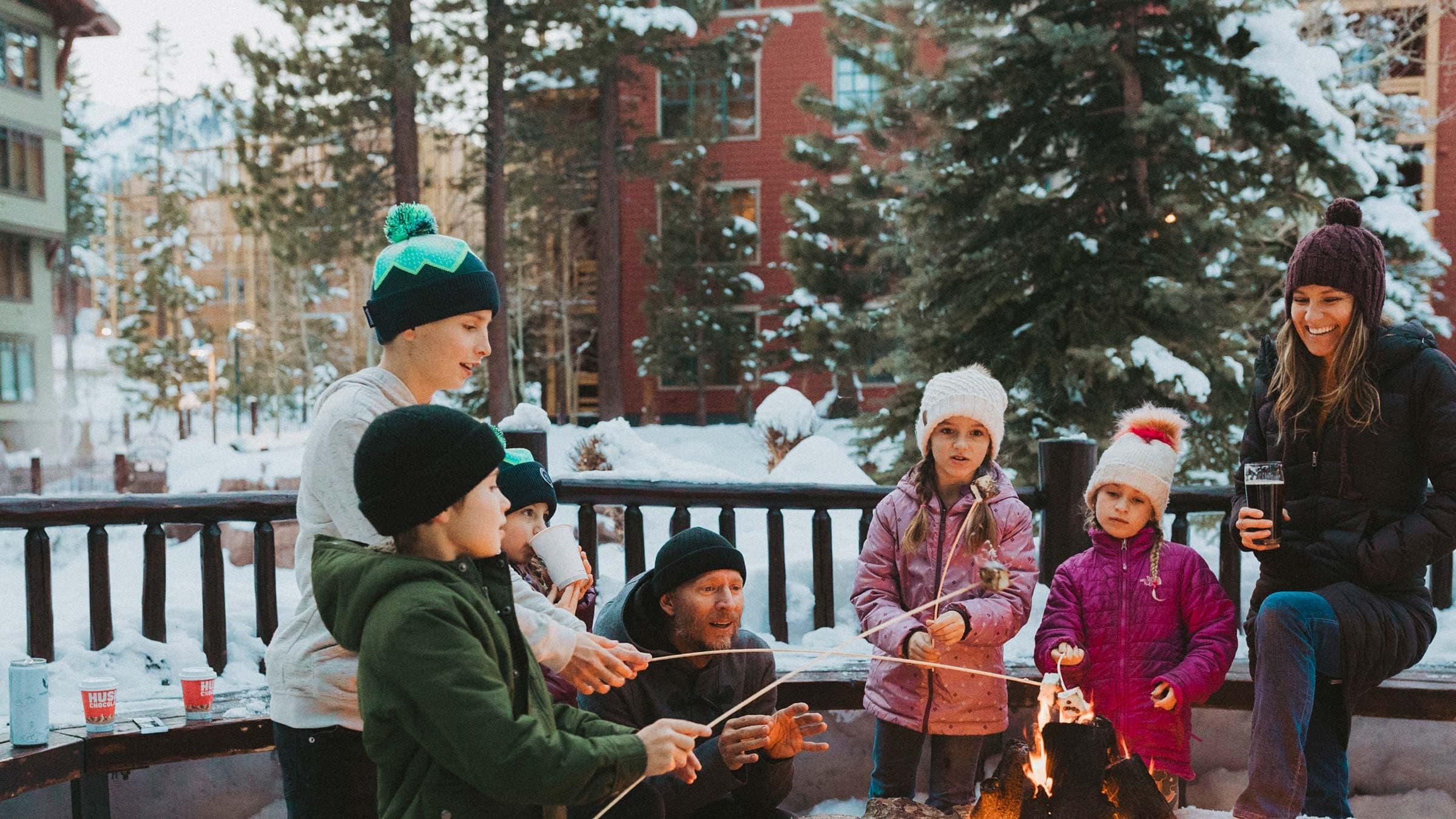 Family roasting smores at The Village