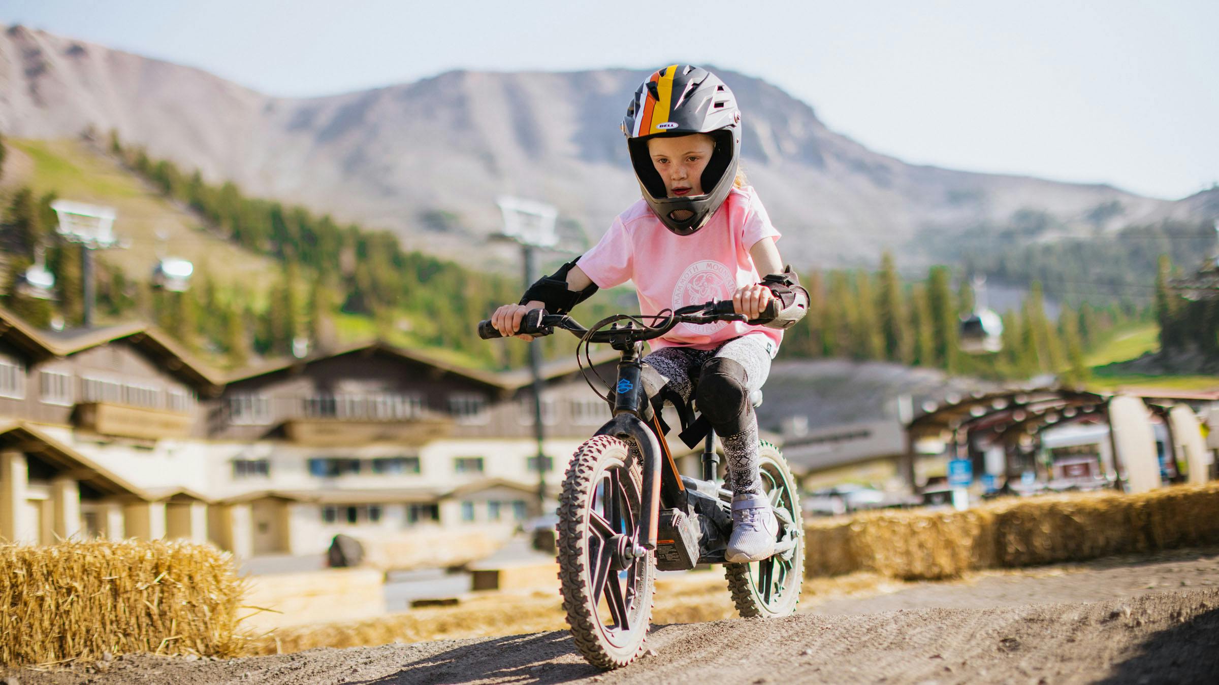 Girl riding bike on STACYC pump track