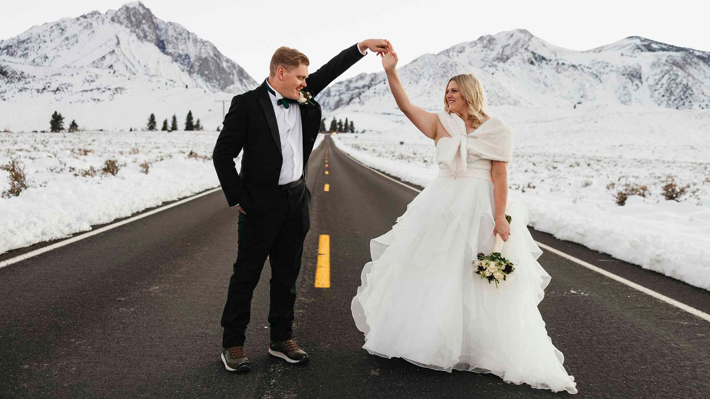 Bride and Groom posing in front of Mountains