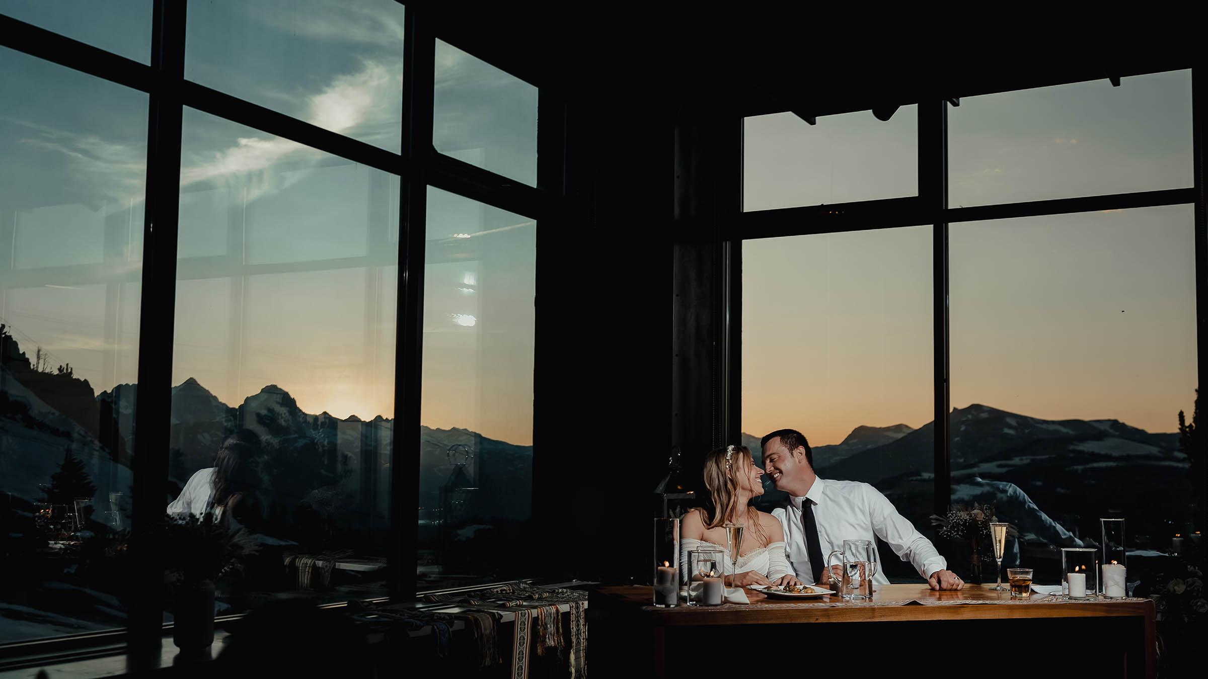 Bride and groom sit at the table during their reception